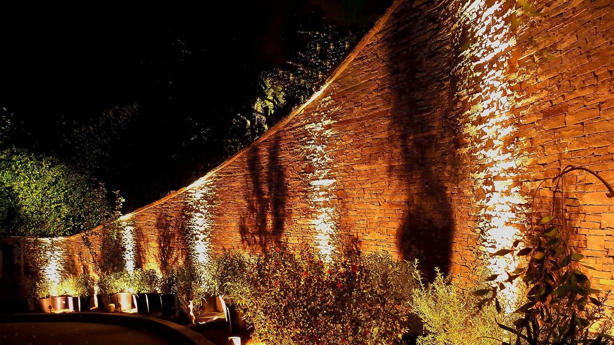 A curved brick wall washed with warm light