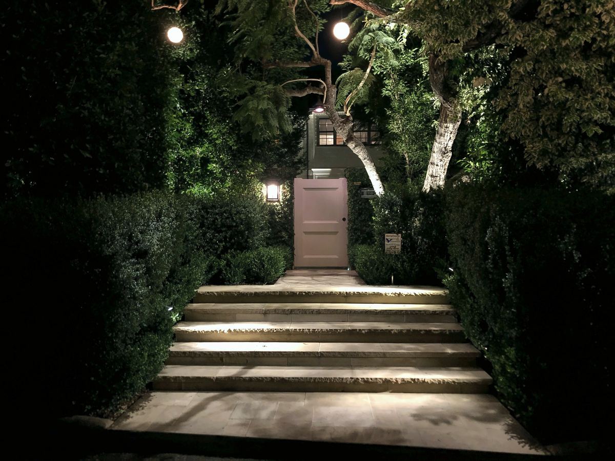 Lit stone steps garden gate