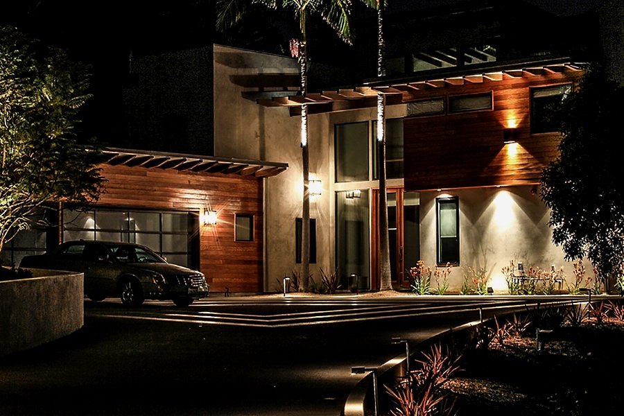 Modern estate facade lit at night