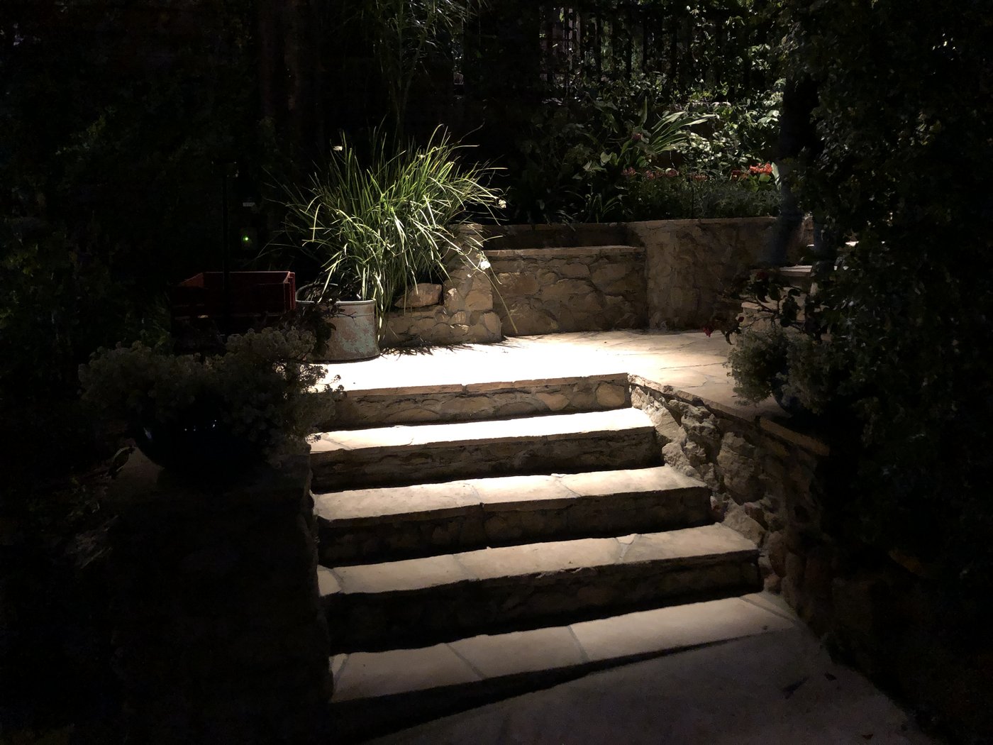 Stone garden steps lit at night
