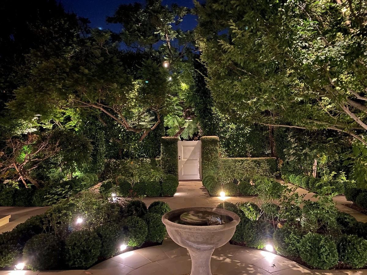 Symmetric garden lit fountain gate