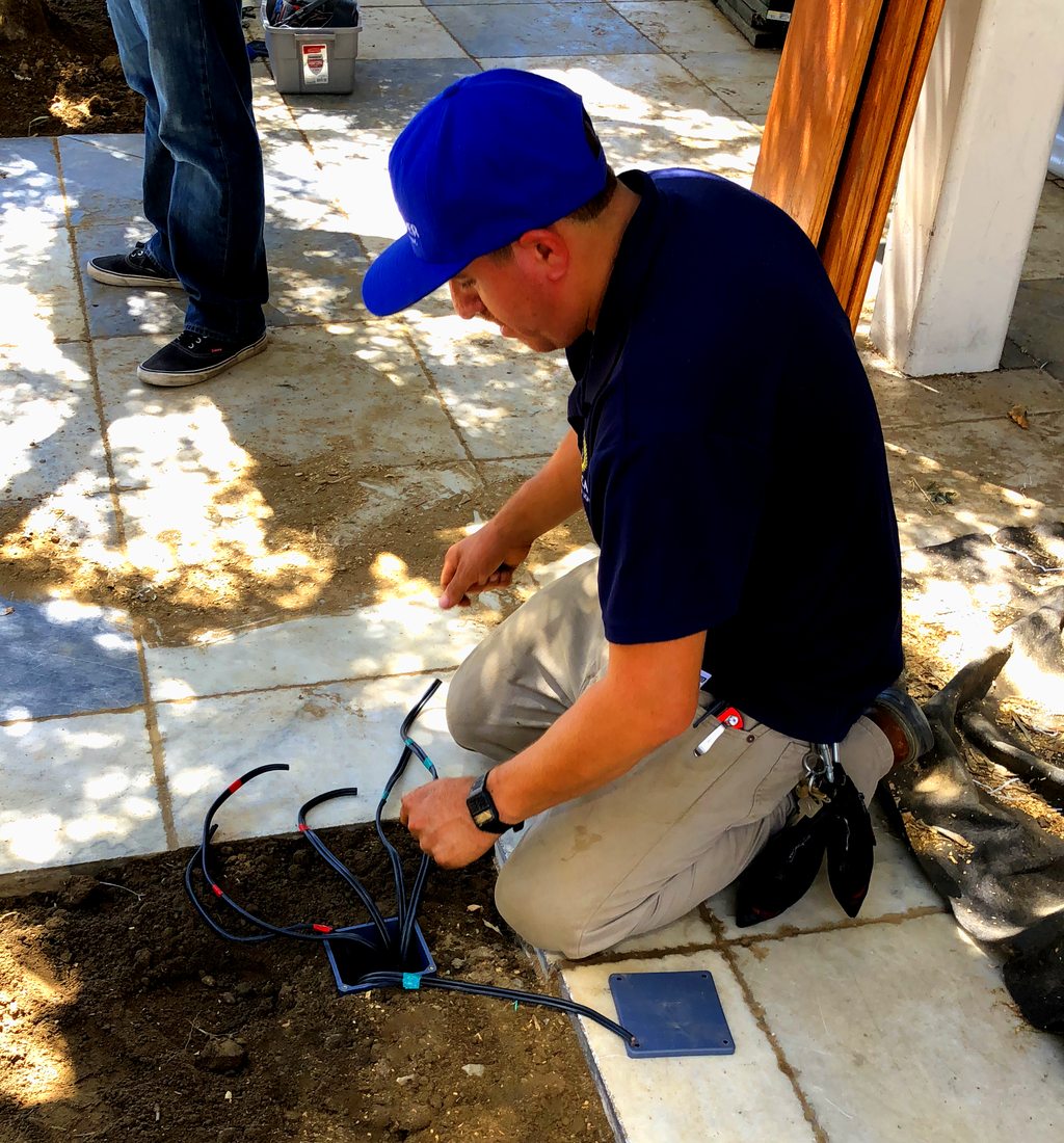 LightScaper installer wiring a low-voltage hub